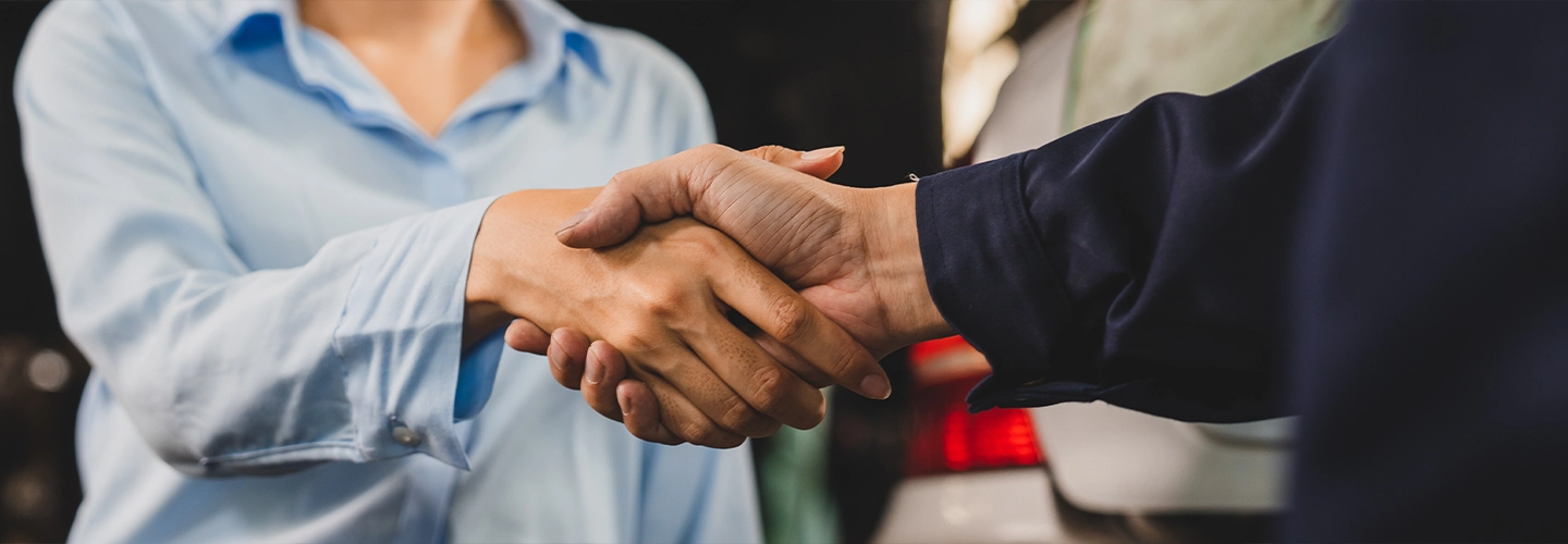 Sales person and customer chaking hands 